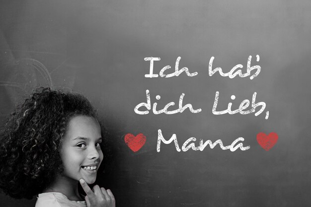 Photo german mothers day message against schoolchild with blackboard