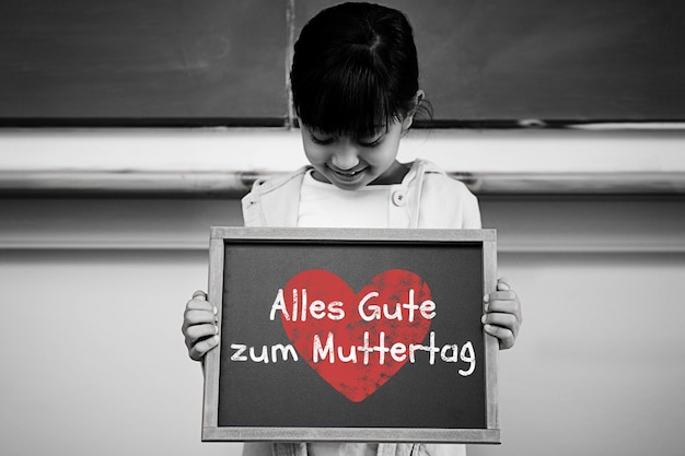 German mothers day message against schoolchild with blackboard