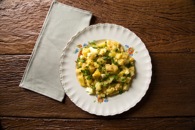 German potato salad with fresh dill in white bowl