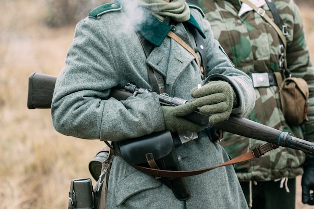 German soldier with a rifle and a cigarette in his hands