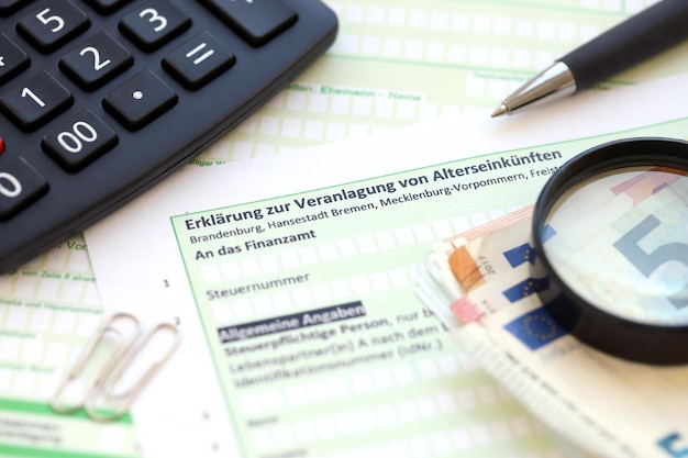german statement on the assessment of retirement income with calculator and european money close up the concept of taxation and accountant paperwork germany
