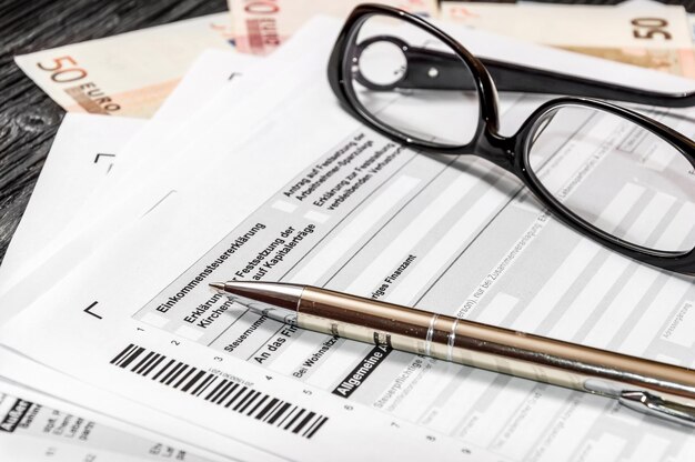 German tax form with pen glasses and euro