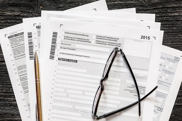 German tax form with pen and glasses on a table