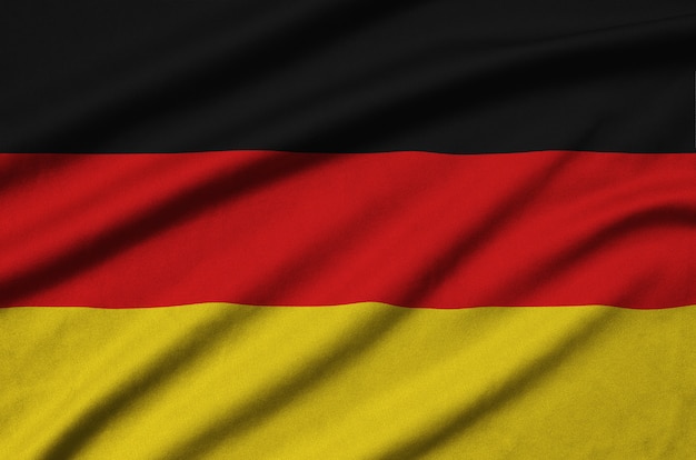 Germany flag is depicted on a sports cloth fabric with many folds.