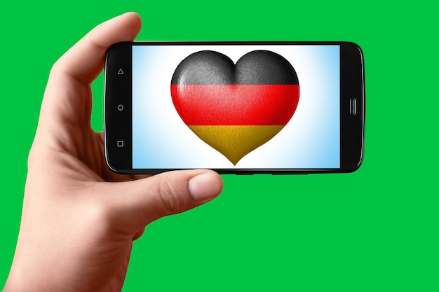 Germany flag in the shape of a heart on the phone screen Smartphone in hand shows the heart of the flag on the background hromakey