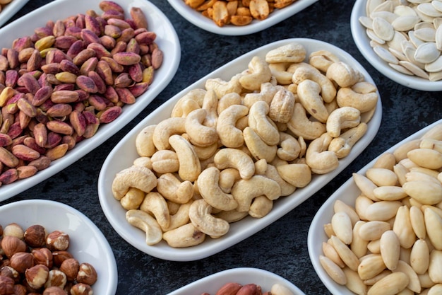 Geroosterde cashewnoten in selectieve focus soorten noten gevonden in bulk op een donkere achtergrond bovenaanzicht noten