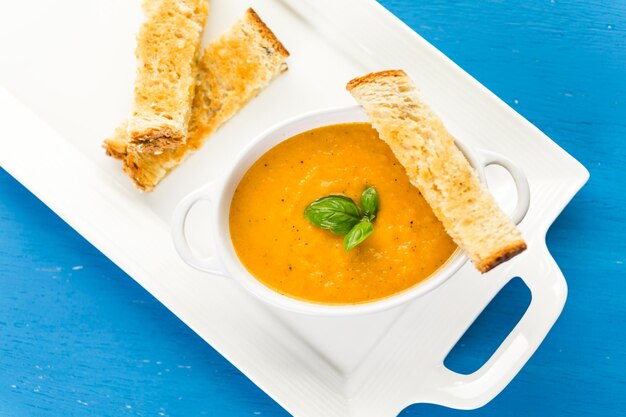 Geroosterde tomatensoep gekookt met biologische heirloom tomaten en geserveerd met tosti.