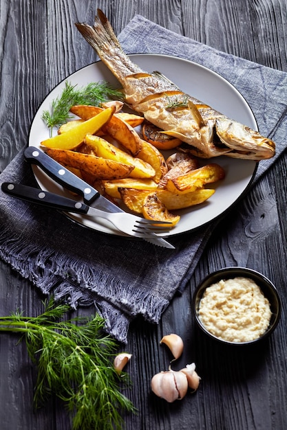 Geroosterde zeebaars op een bord met frietjes