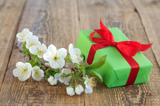 Geschenkdoos met tak van mooie jasmijn bloemen op de houten achtergrond