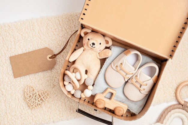 Foto geschenkmand met genderneutraal babykledingstuk en accessoires