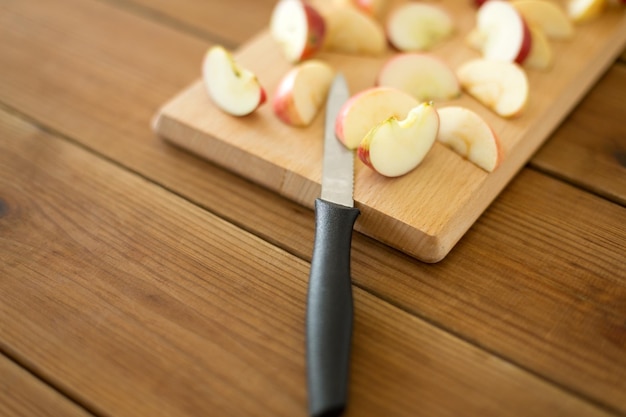 Foto gesneden appels en mes op een houten snijplank