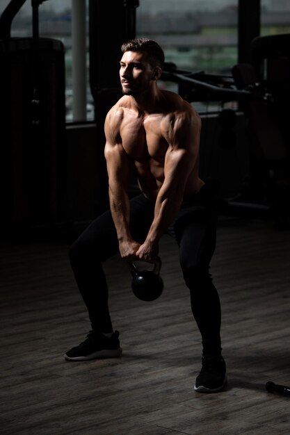 Gespierde man oefenen met kettlebell