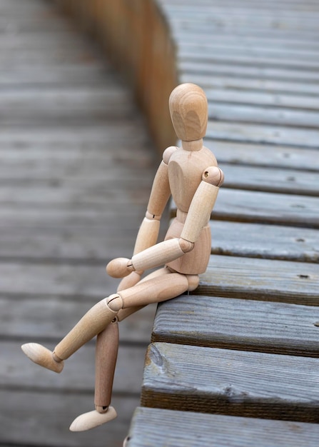 Gestalta figure sitting in bench in empty outdoor amphitheater