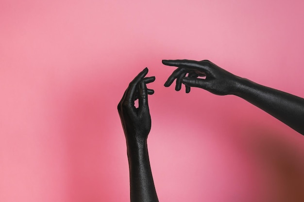 Photo gesticulation of black painted elegant womans hands on her skin high fashion art concept