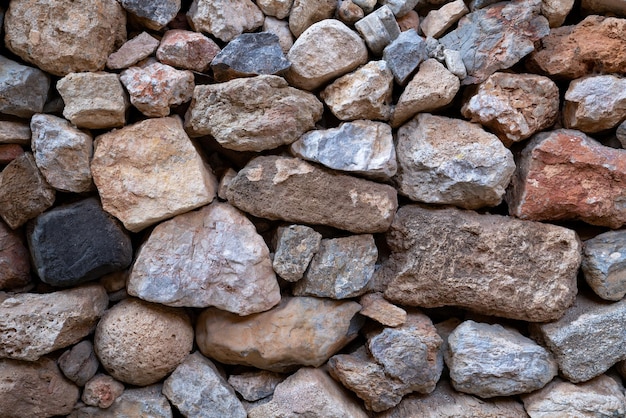 Gestructureerde achtergrond van metselwerk muur gemaakt van veelkleurige stenen Close-up