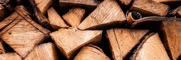 Gestructureerde brandhoutachtergrond van gehakt hout voor het aansteken en verwarmen van het huis. een houtstapel met gestapeld brandhout. de textuur van de berkenboom. banier