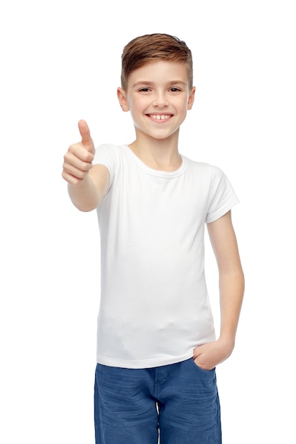 gesture, childhood, fashion, advertisement and people concept - happy smiling boy in white blank t-shirt showing thumbs up