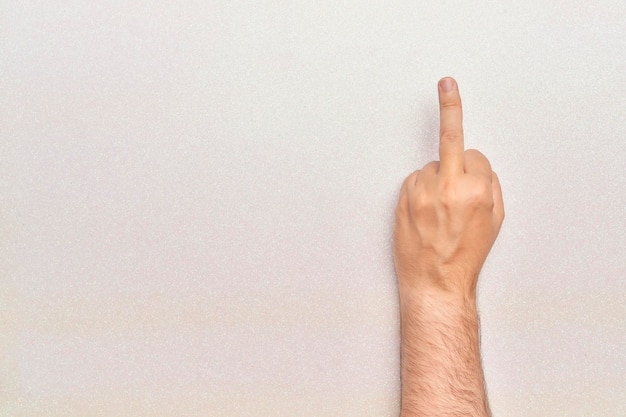 Gesture the middle finger on bright white background fuck off with horizontal copy space