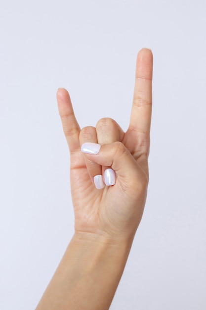 Gesture and sign hand on white background Hand showing rock