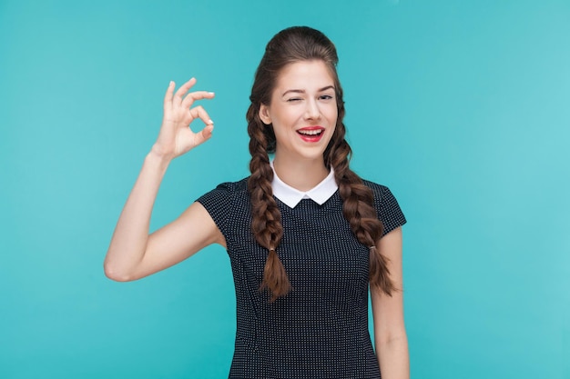 Gesture woman toothy smile and showing ok sign at camera