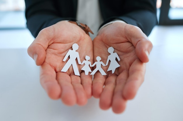 Get cover for your loved ones. Shot of a unrecognizable man holding a image of a family in a office.