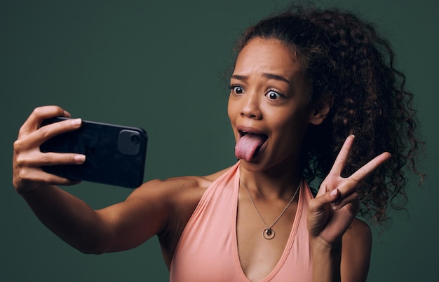 Getting creative with her photography Cropped shot of an attractive and quirky young woman posing against a green background in studio