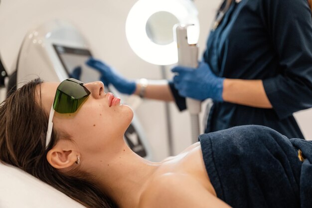 Photo getting photo rejuvenation procedure at cosmetology clinic women in beauty salon