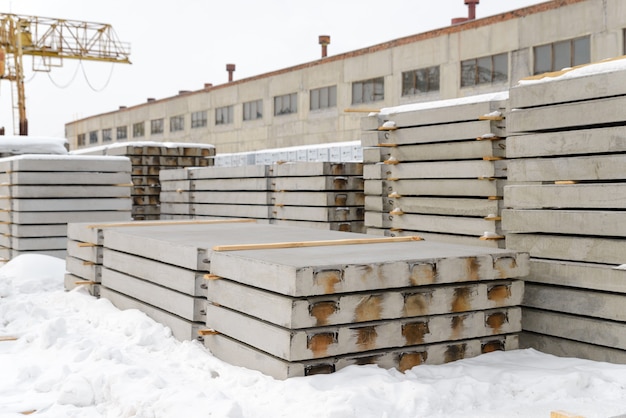 Gewapende betonplaten bestemd voor de aanleg van wegen en vliegvelden. Opslag in het magazijn van de prefab betoncentrale.