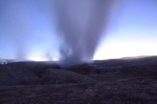 A geyser shoots out of the ground a photo at dawn on a long exposure on Eduardo Avaroa National Reserve in Uyuni