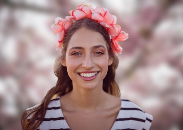 Gezicht van de vrouw in roze bos met bladeren en bloemen op het hoofd