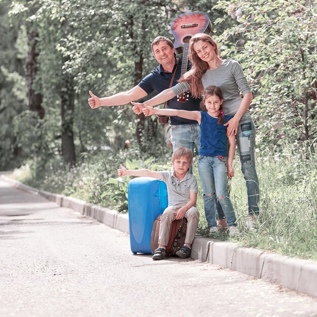 Gezin met kinderen die aan de kant van de weg stemmen