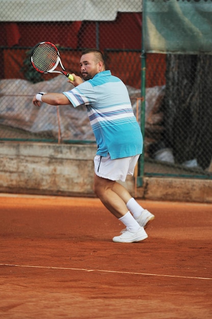 gezonde jonge man speelt tennis met vriend buiten