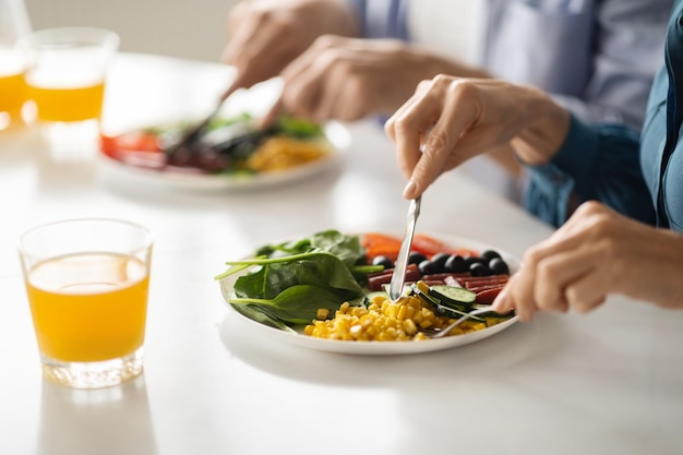 Gezonde maaltijd man en vrouw lekker eten in keuken close-up