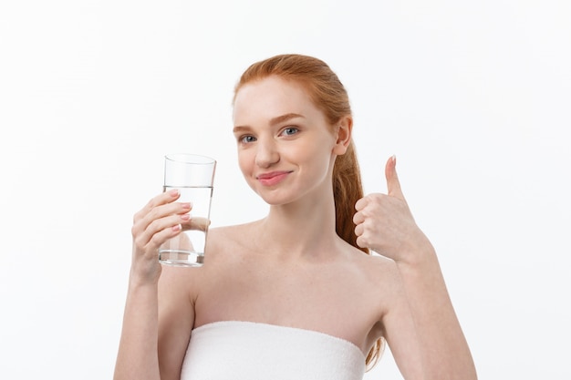 Gezondheid, mensen, eten, sport, lifestyle en schoonheidsinhoud - Glimlachende jonge vrouw met een glas water.