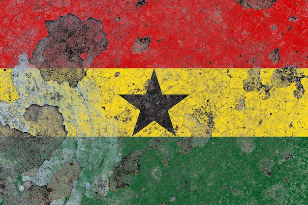 Ghana flag on a damaged old concrete wall surface