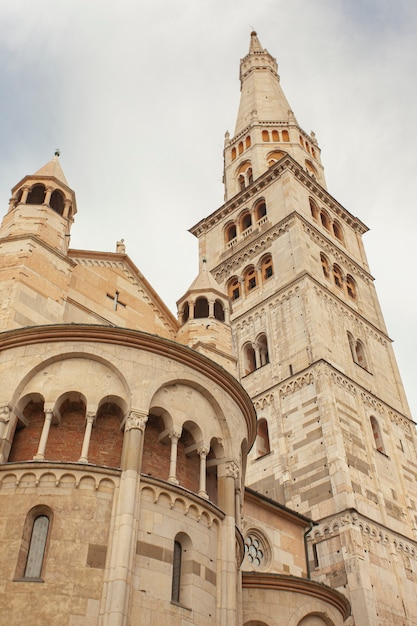 Ghirlandina ancient tower and duomo from below in Modena city, Italy