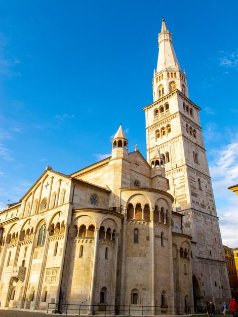 The ghirlandina the bell tower of modena italy and the wonderful romanic dome against the blue sky