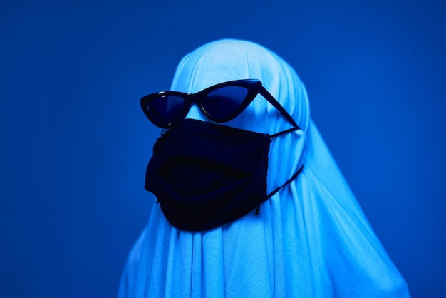 Ghost in glasses wears a mask to protect against coronavirus funny preventative suit for coronavirus