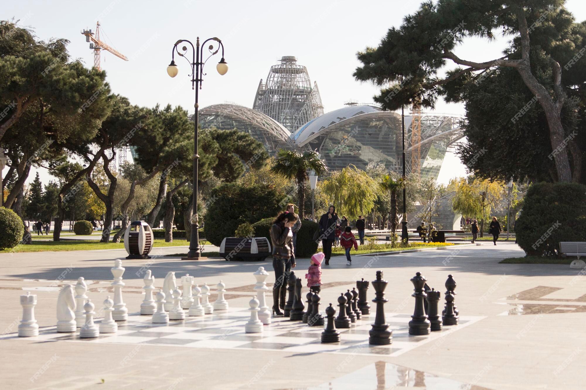 Sculptures and a giant chess set decorate a plaza as part of Louis Vuitton  art installation.jpeg