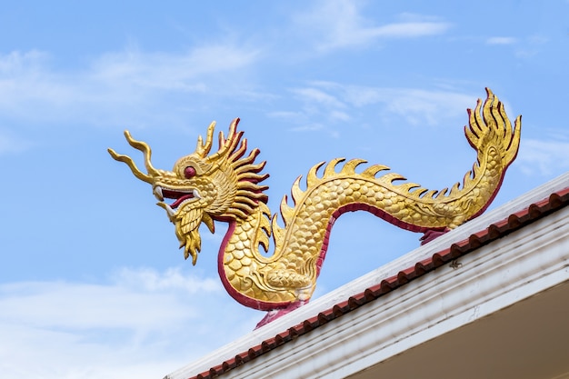 Giant chinese style dragon statue on blue sky background