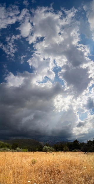 Giant Cumulus clouds before the approaching summer storm in a village on the Greek island in Greece