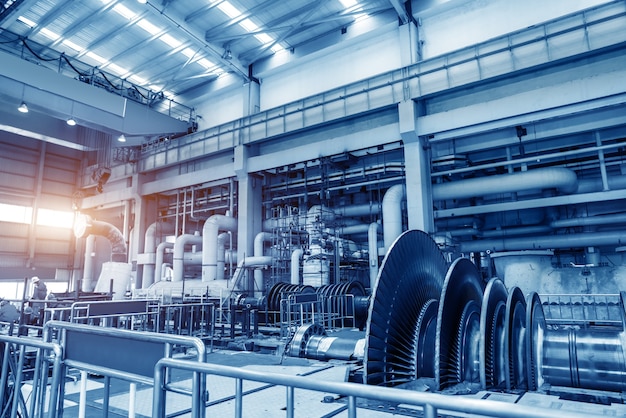 Giant pipes, tubes and equipment inside modern industrial power plant