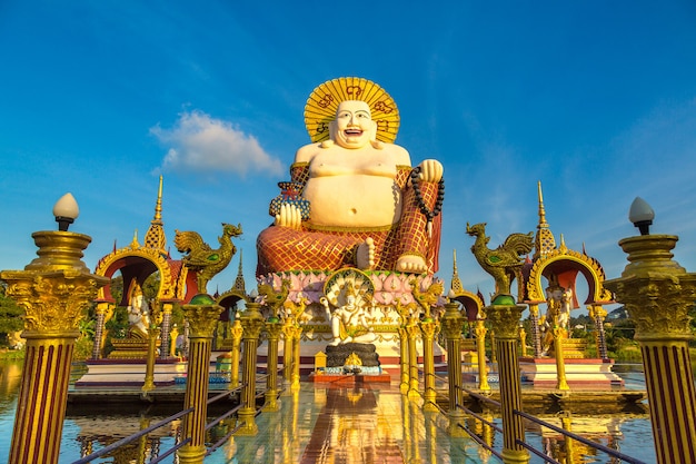 Giant smiling or happy buddha statue in Wat Plai Laem Temple, Samui, Thailand