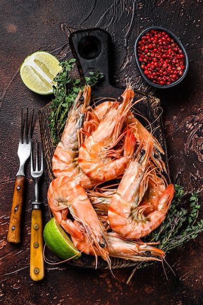 Giant Tiger Prawns shrimps on a cutting board with herbs