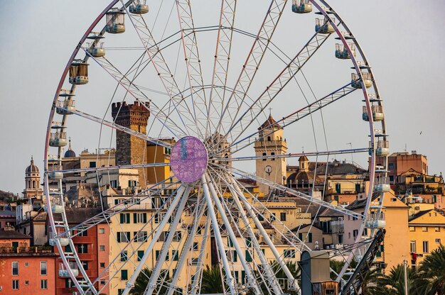 A giant touristic ferris wheel in the old harbour of genoa italy