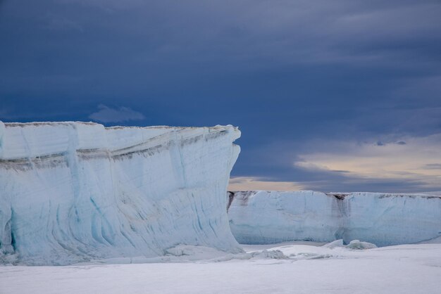 Giantic pushed up ice floes of sea ice in the antarctica with dramatic dark sky in the background