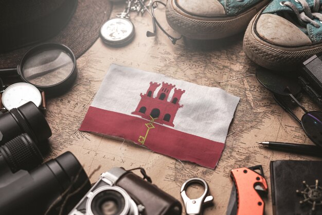 Gibraltar Flag Between Traveler's Accessories on Old Vintage Map. Tourist Destination Concept.