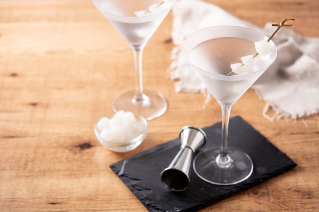 Gibson martini cocktail with onions on wooden table