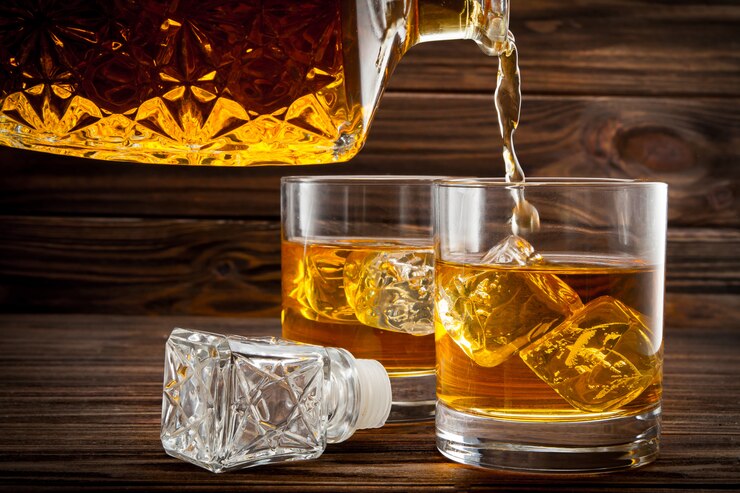 Gieten whisky uit de fles in de glazen