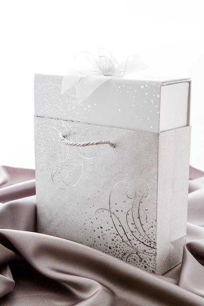 Gift box of assorted gourmet chocolate truffles on silver silk.